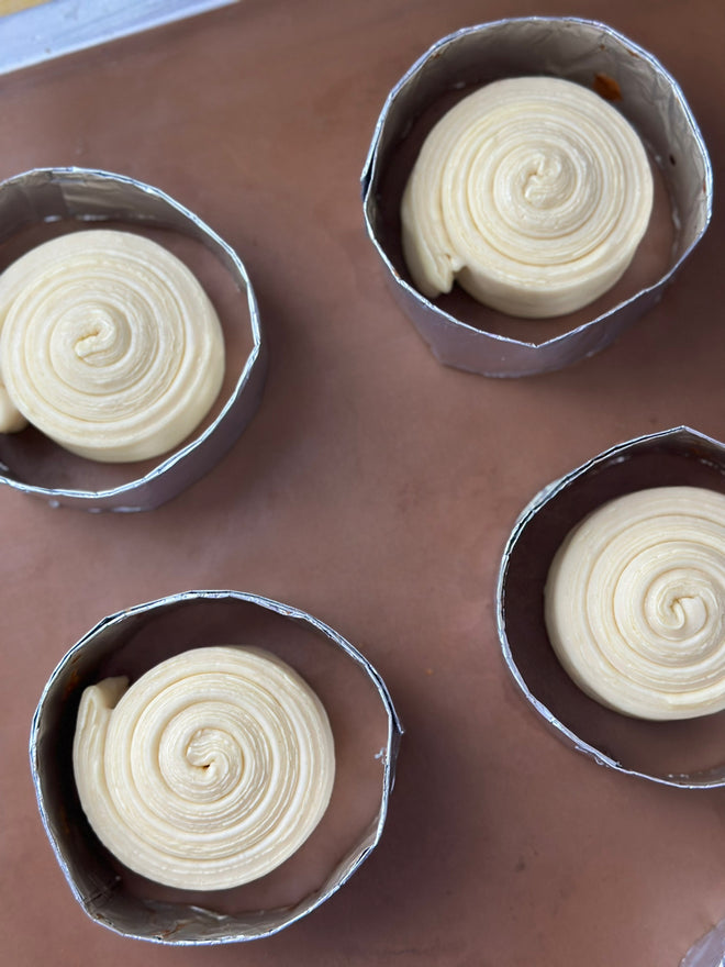 Rolled pastry spirals proofing in tins, customer photo from a Shopee review