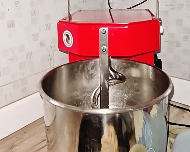 Customer photo of a red Golden Chef DH-8W spiral mixer with dough in the bowl