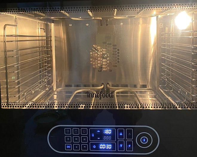 Innofood KT-V88 oven cavity with side racks and the digital control panel lit at 180 degrees